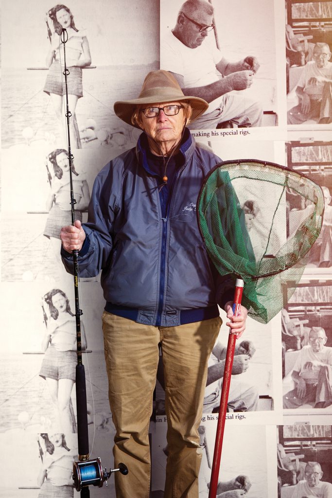 Captain Judy standing with her fishing gear