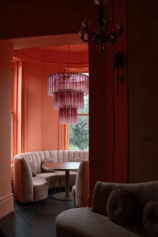 pink upholstered booths in pink room with pink chandelier