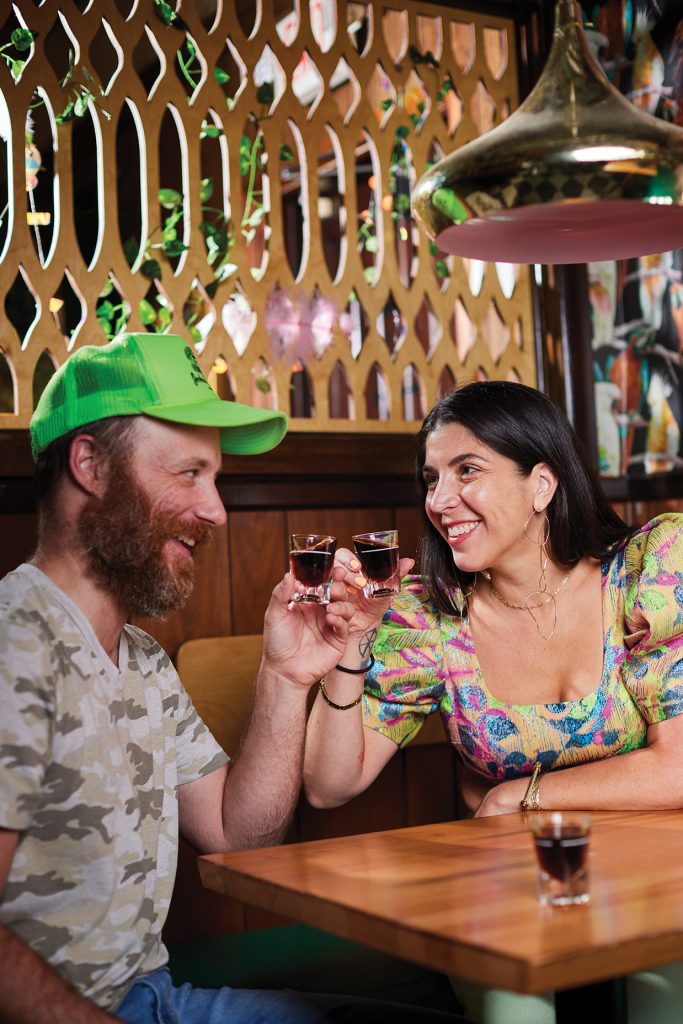 Man and woman drinking shots of whisky