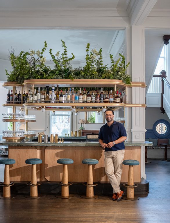 man leaning against a hotel bar