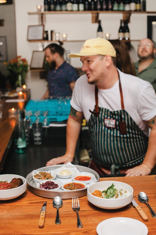 Chef talking with diners at a restaurant pop-up