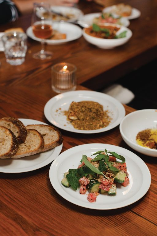 Plates of food sitting on a bar as part of restaurant pop-up