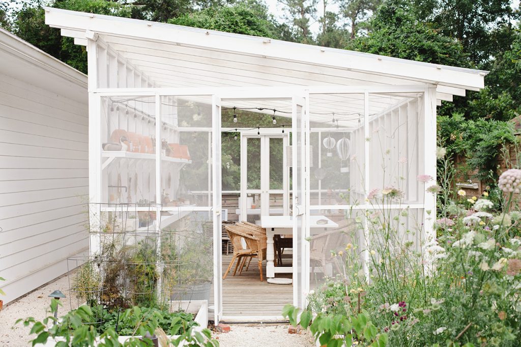 Screened garden house with dining table