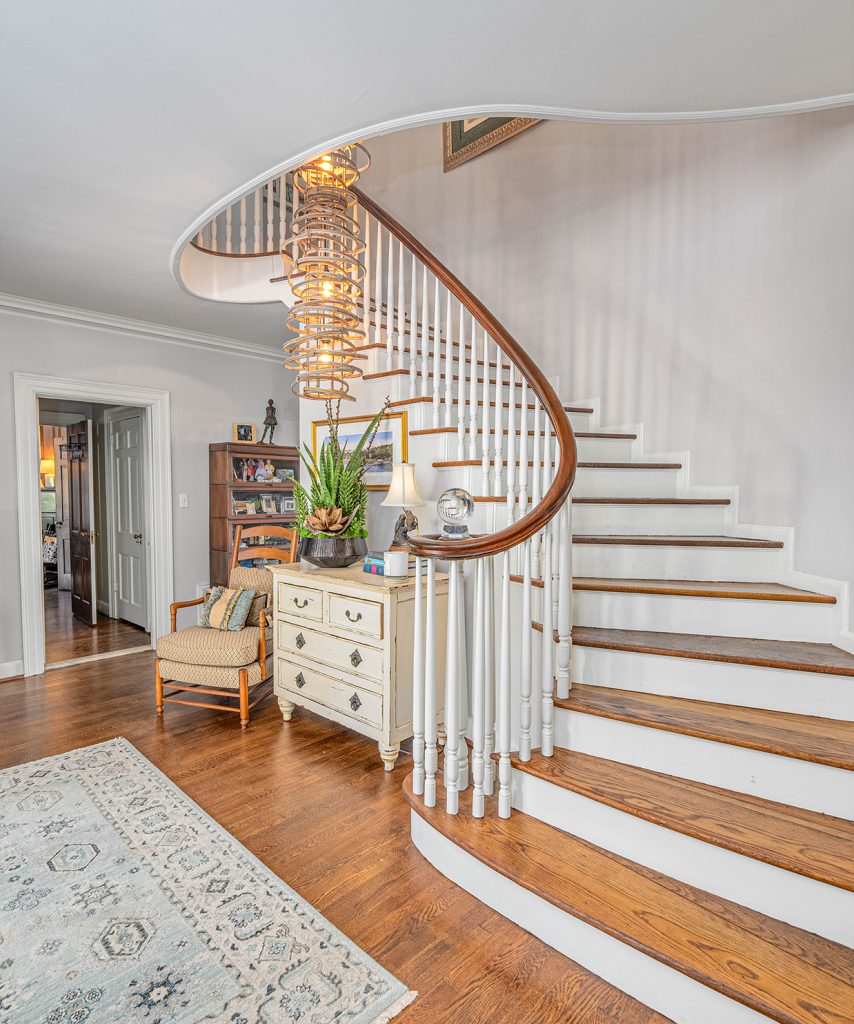 Winding staircase in mansion entryway