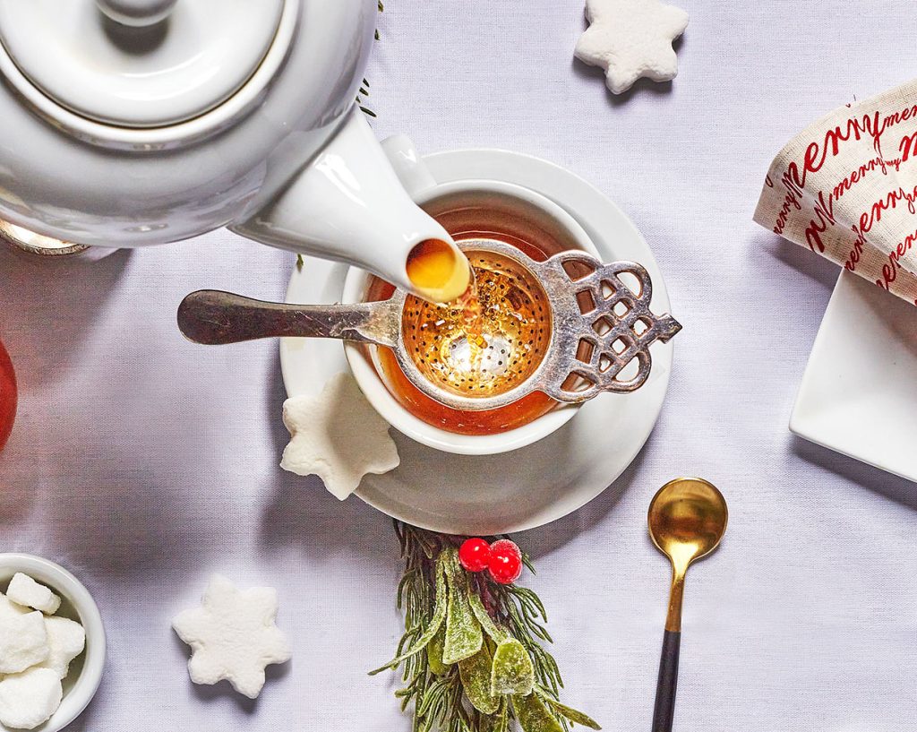 Tea being poured from a pot into a tea cup