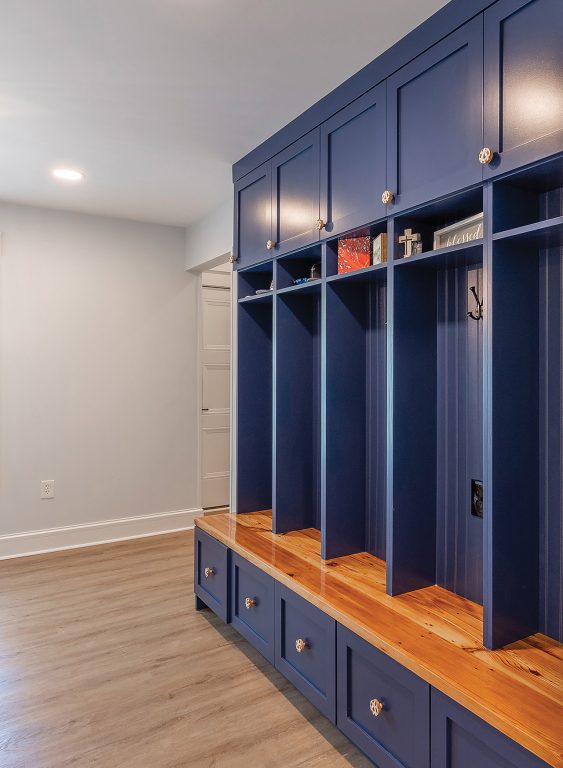 dark blue floor-to-ceiling mud room storage cubbies