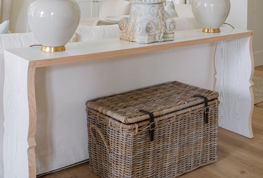 Whicker storage trunk under a table