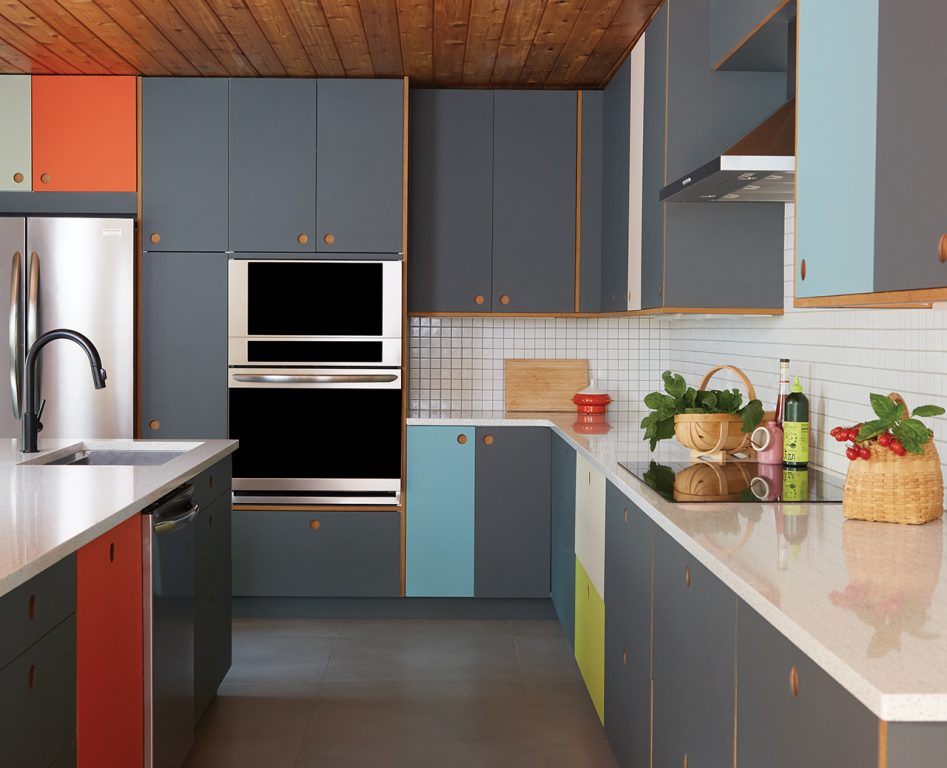 Minimalist kitchen with gray, blue, green and orange cabinets and white square tile backsplash