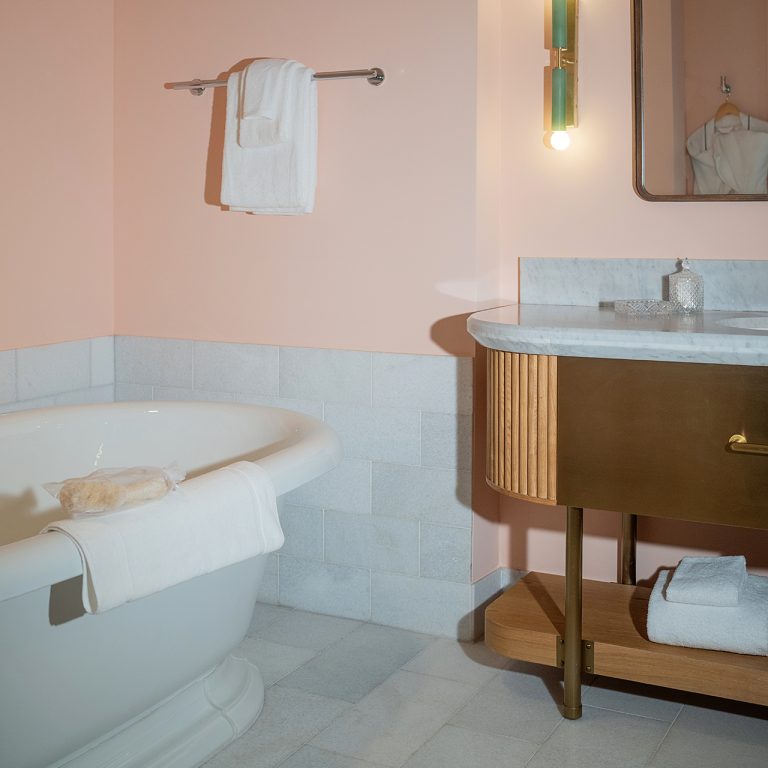 A soaking tub and vanity in an upscale hotel bathroom