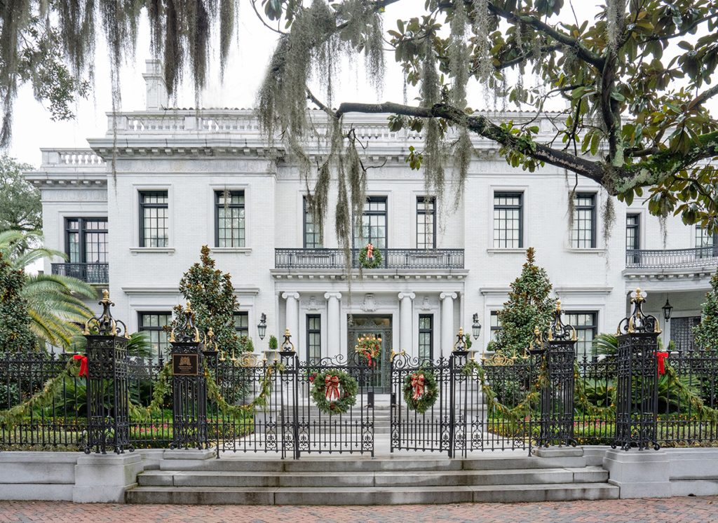 The front of Kessler Mansion decorated with holiday wreaths and bows