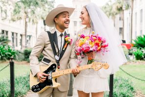 Bride holding bouquet and groom holding a guitar