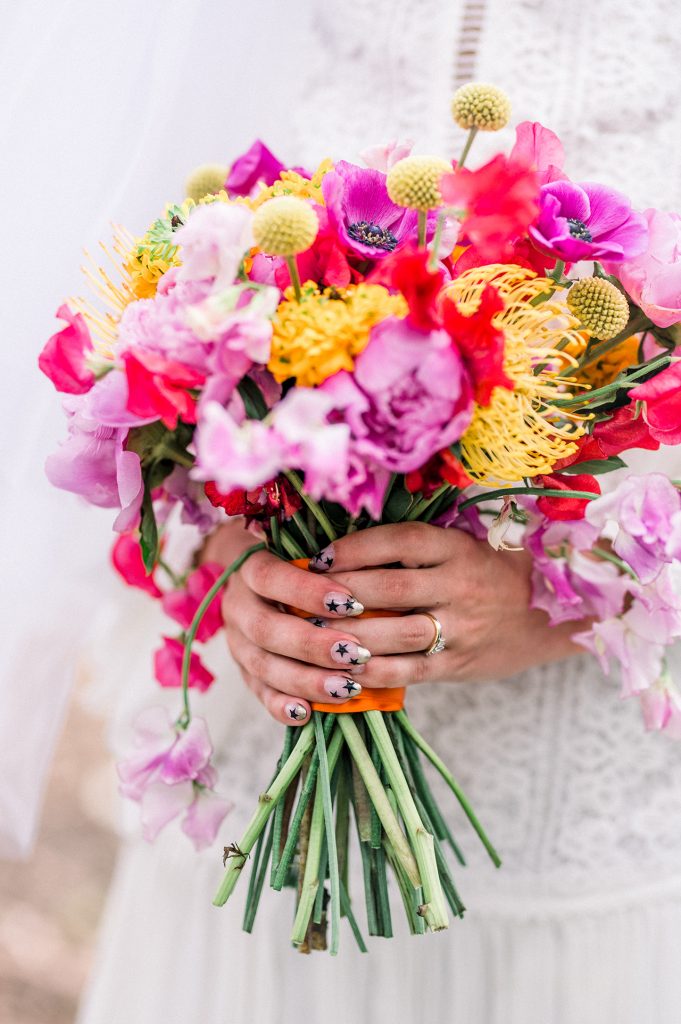 bride holding a colorful bouquet