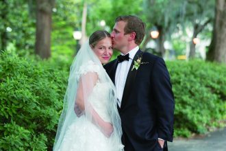 a groom kissing his bride on the forehead