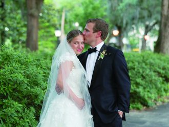 a groom kissing his bride on the forehead