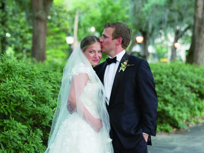 a groom kissing his bride on the forehead