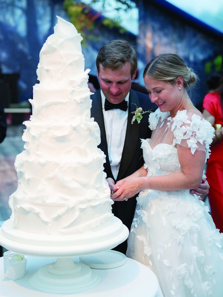 bride and groom cutting their five-tier wedding cake