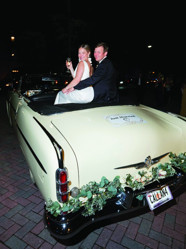 bride and groom in a vintage convertible