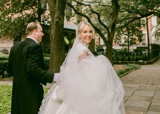 bride and groom walking under a canopy of trees