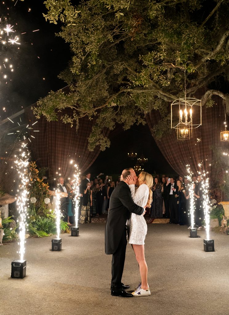 Kissing bride and groom surrounded by sparklers