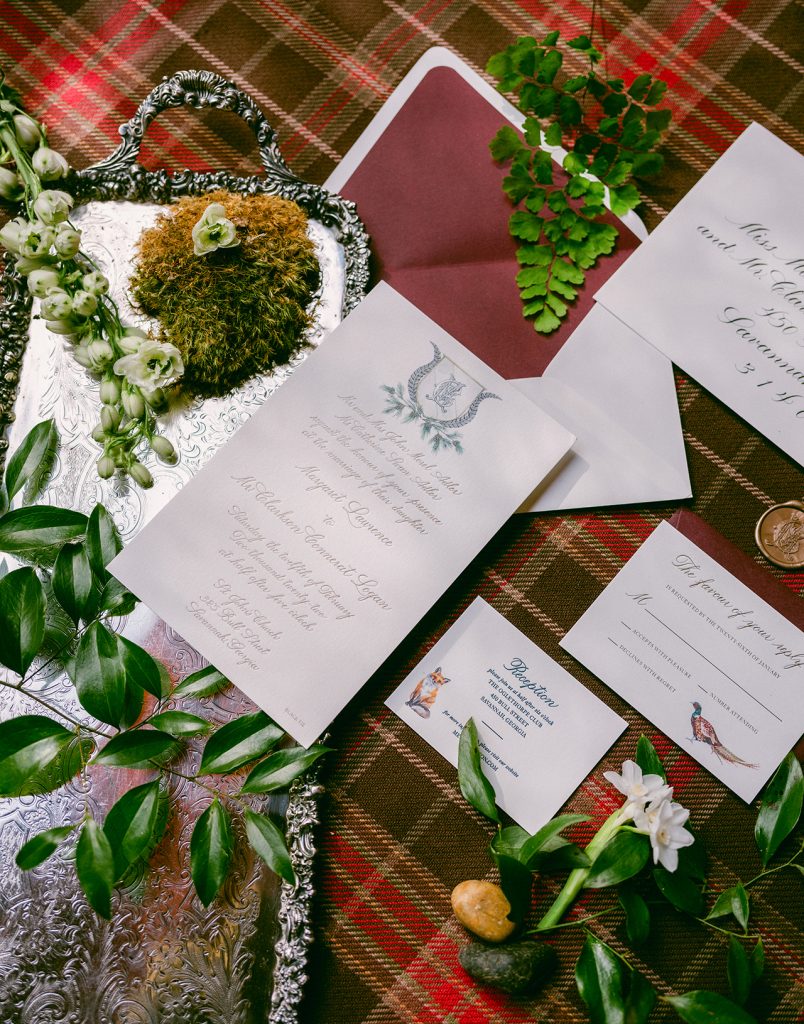 wedding invitations on a plaid tablecloth