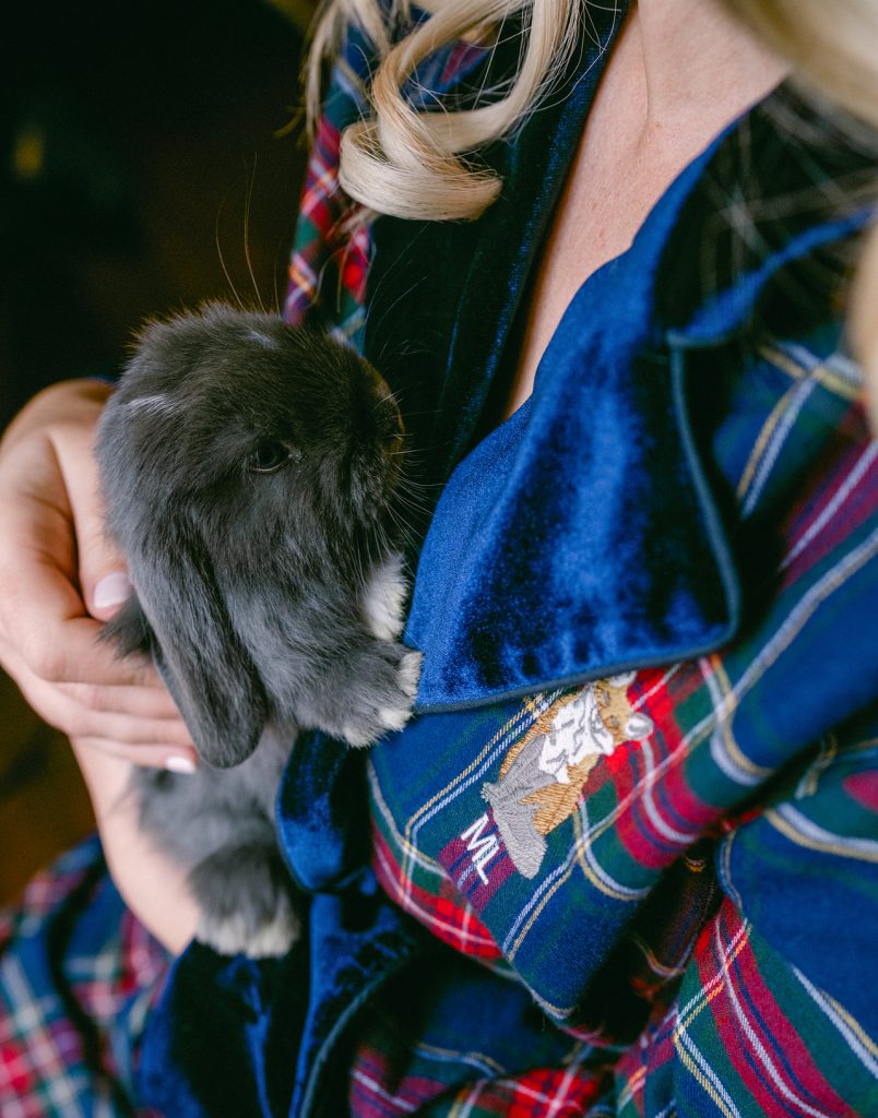 woman holding a gray rabbit